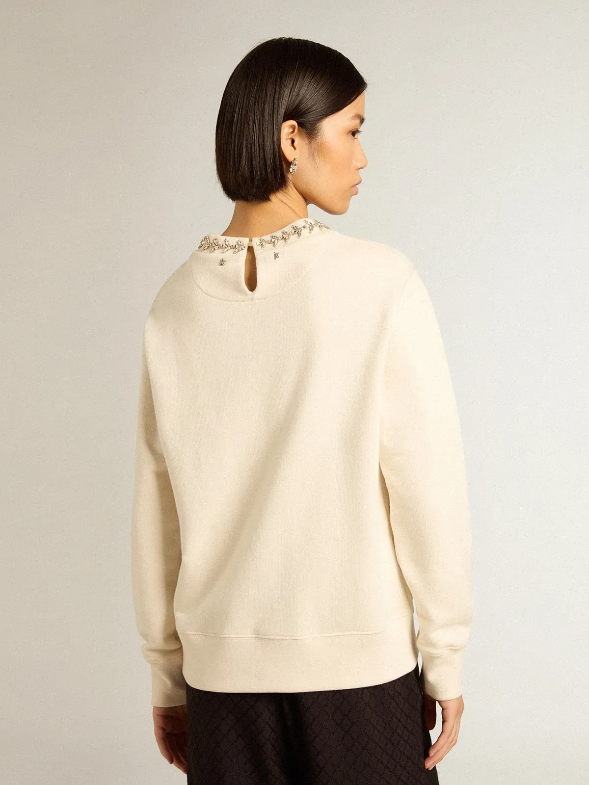 Round-neck cotton sweatshirt in aged white with hand-applied crystals